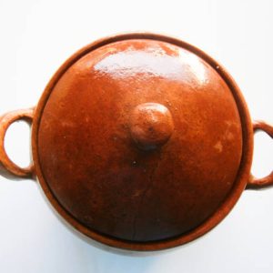 Clay pot of Peruvian cuisine on a white surface and widely used in the preparation of Peruvian meals.